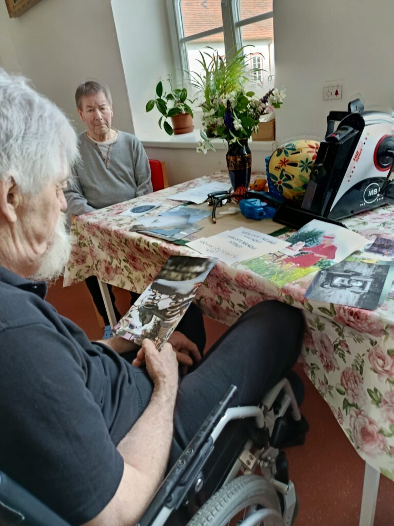 Dva klienti u stolu, prohlíží si fotografie a obrázky na téma jízdní kolo
