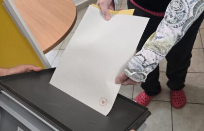 Volič vhazuje své hlasy do přenosné urny